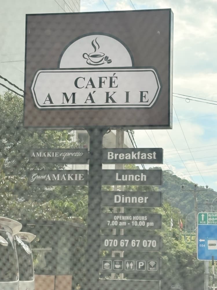 Café Amakie roadside sign offering breakfast, lunch and dinner, open 7 am to 10 pm, near the Kurunegala expressway exit