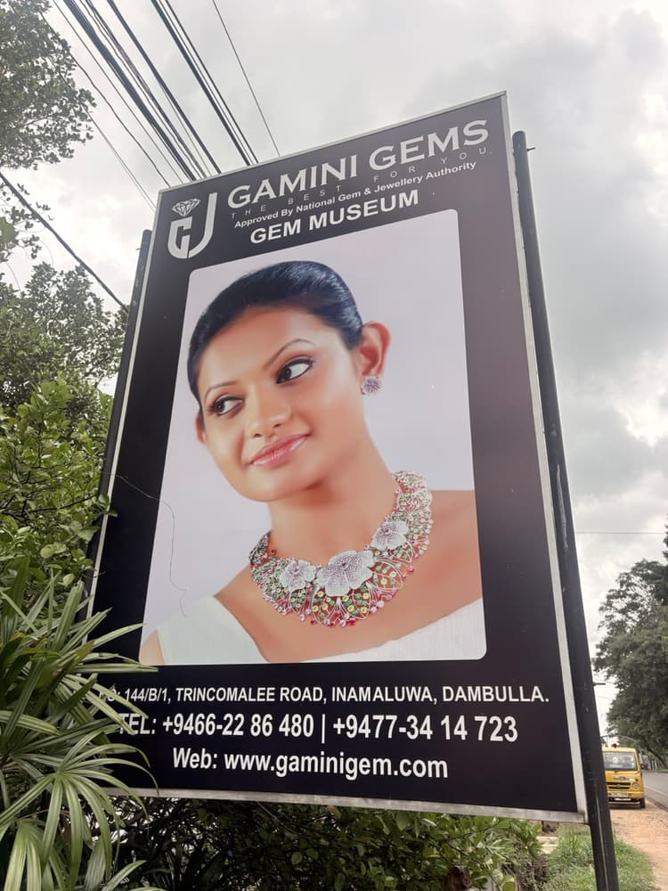 Gamini Gems gem museum billboard on Trincomalee Road at Inamaluwa, Dambulla