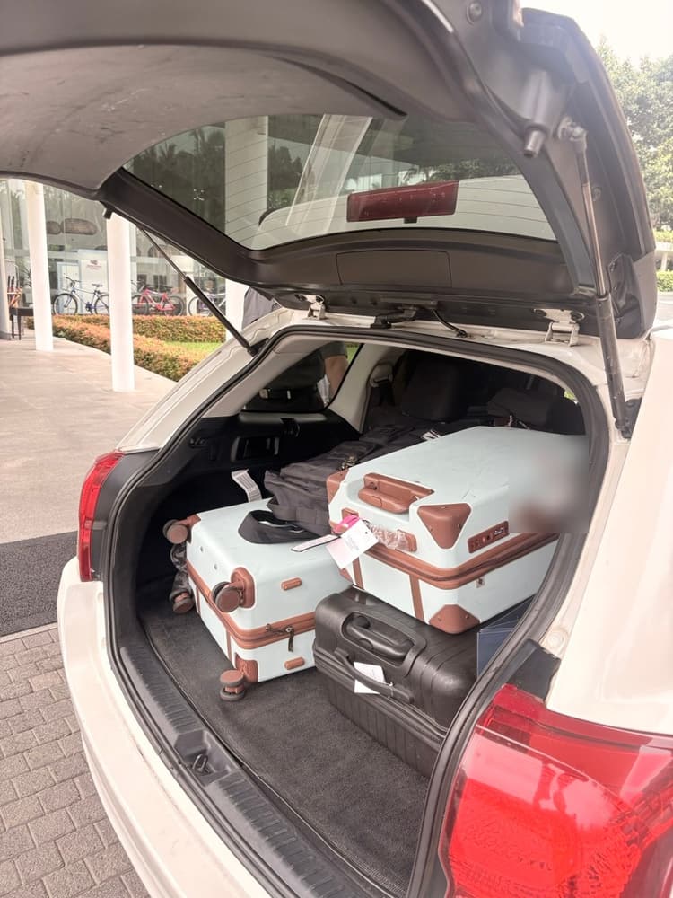 Suitcases loaded in the boot of a TaxiGo car outside Vivanta Colombo Airport Garden, ready for the airport